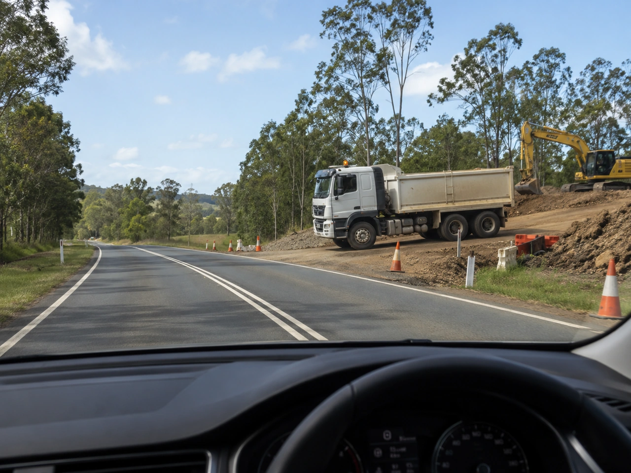 What should you do when construction vehicles enter or leave the road?