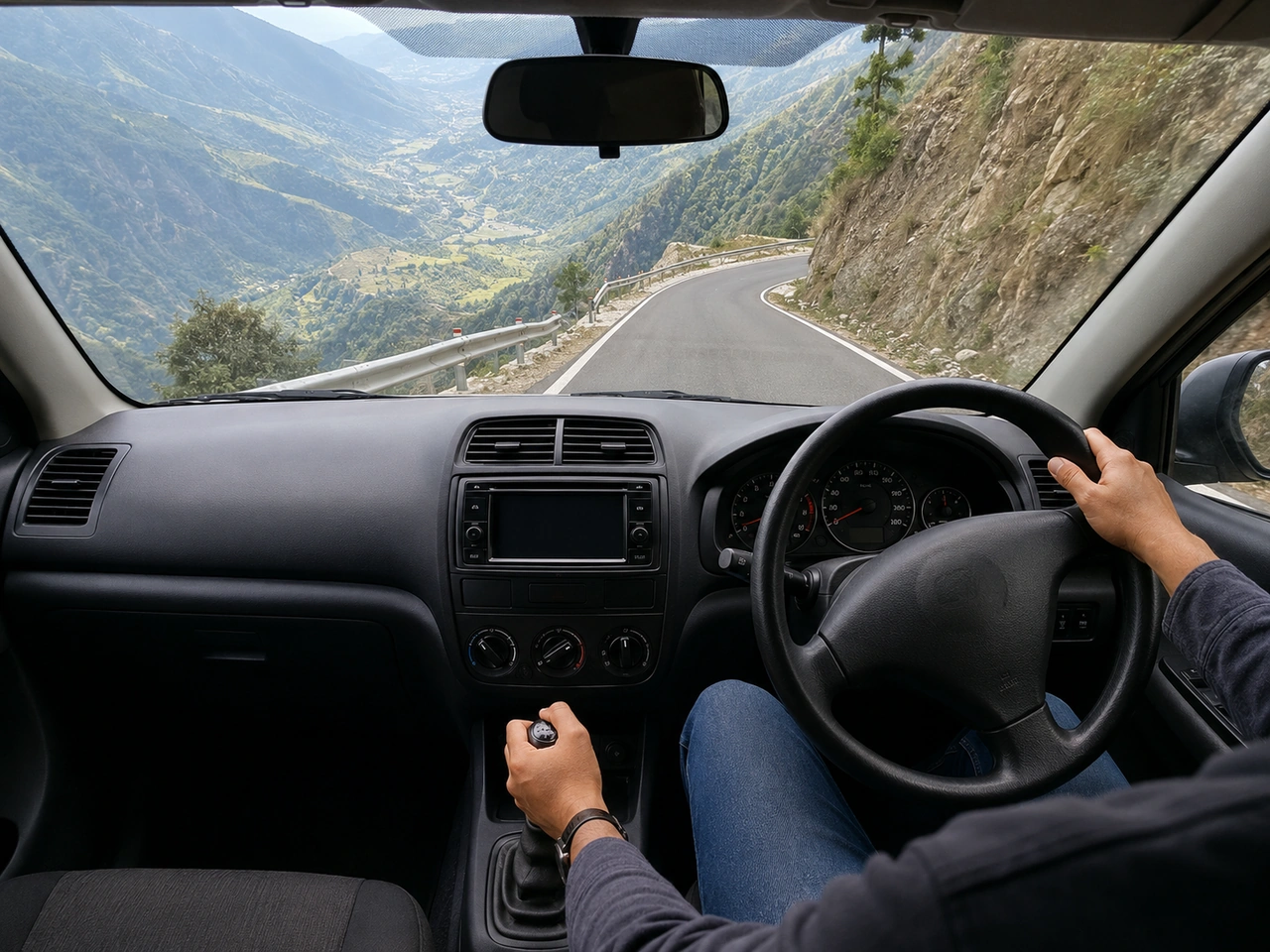 Why should you use a lower gear when driving downhill?