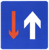 Road narrowing, oncoming drivers have to give way.
