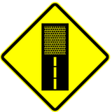 Warning for an unpaved road surface.