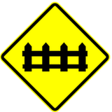 Warning for a railway crossing with barriers.