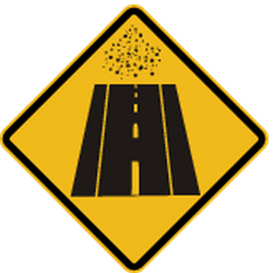 Warnung vor unbefestigter Fahrbahn.