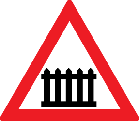Warning for a railway crossing with barriers.