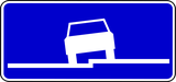 Parallel parking partially on pavement.