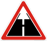Warning for an unpaved road surface.