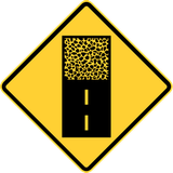 Warning for an unpaved road surface.