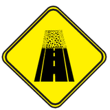 Advertencia de calzada sin pavimentar.